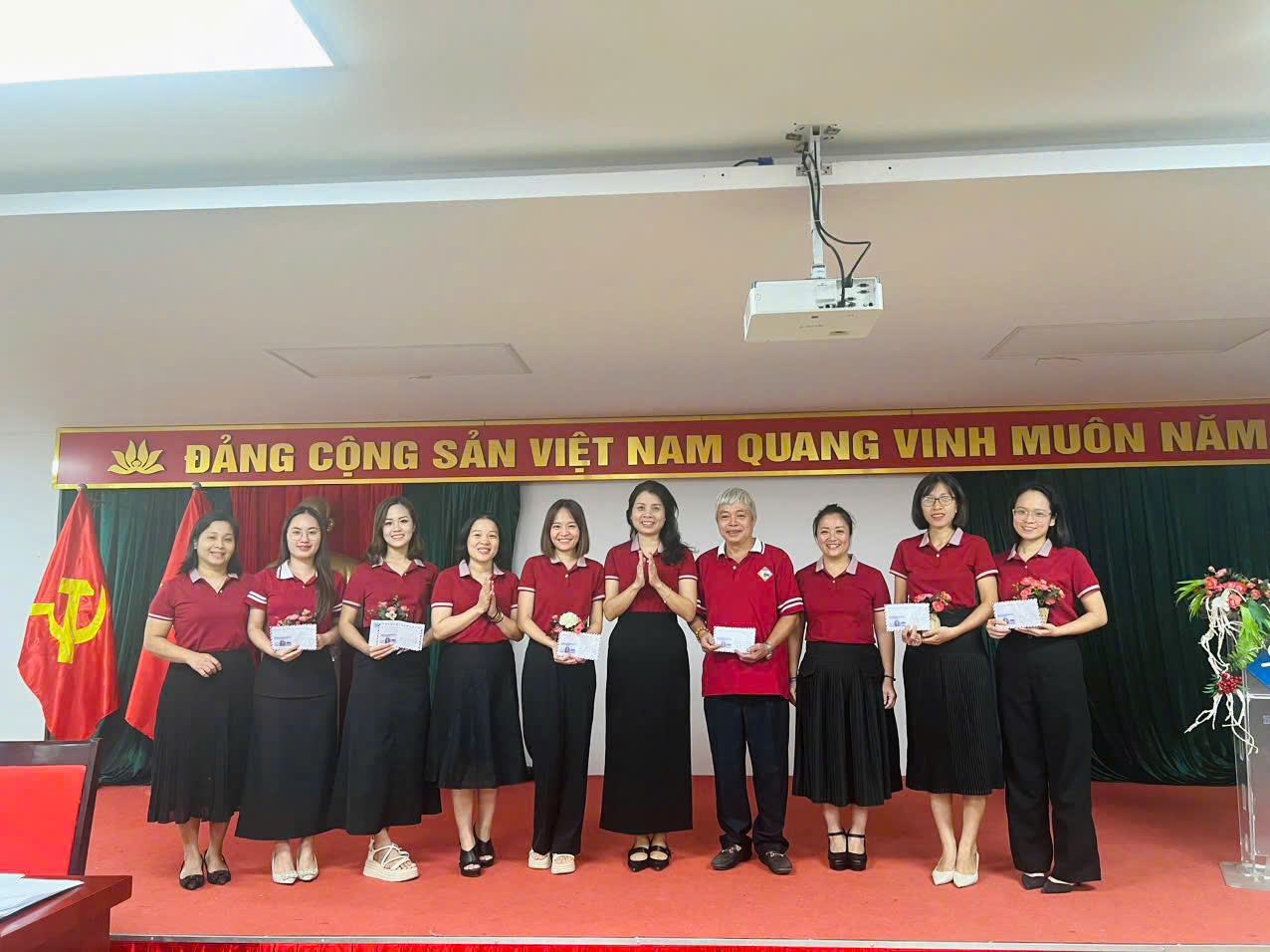 A group of women standing on a stageDescription automatically generated