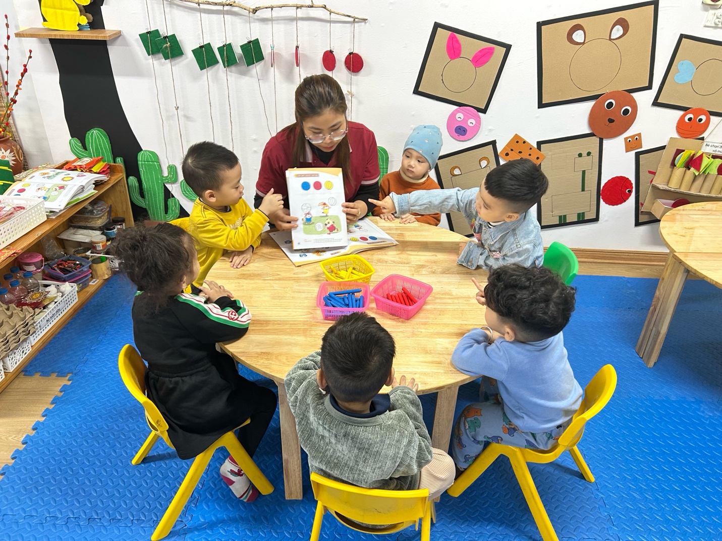 A group of children sitting around a table

AI-generated content may be incorrect.