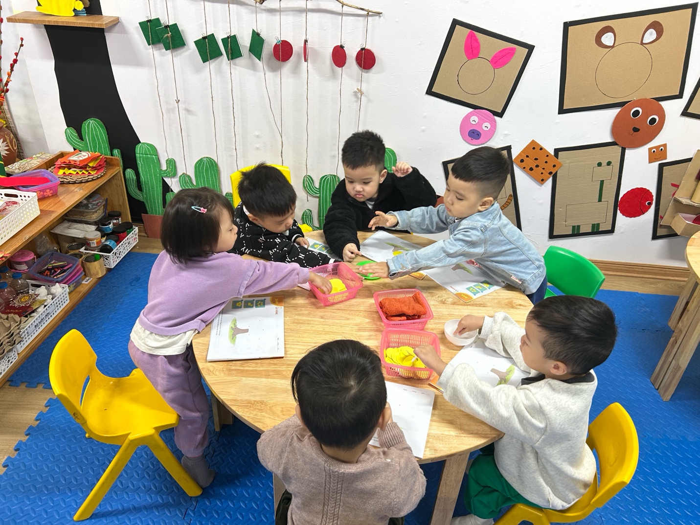 A group of children sitting around a table

AI-generated content may be incorrect.
