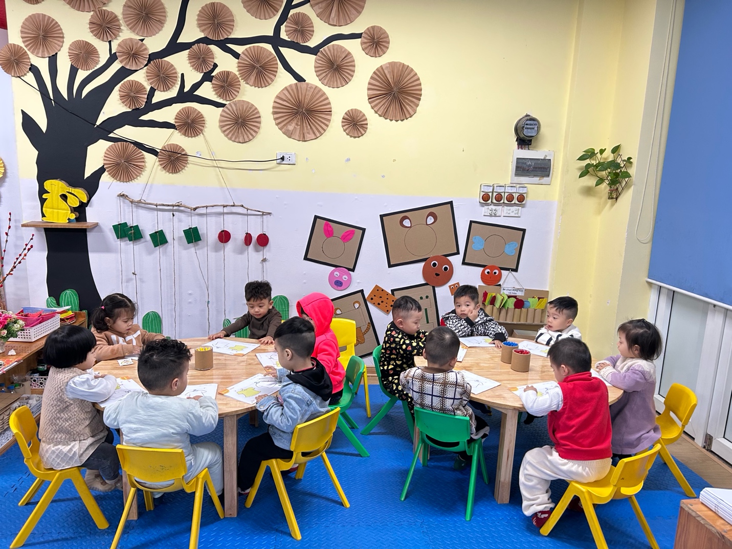 A group of children sitting at a table

AI-generated content may be incorrect.