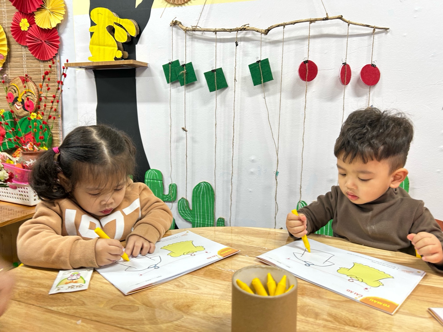 A two children sitting at a table coloring

AI-generated content may be incorrect.