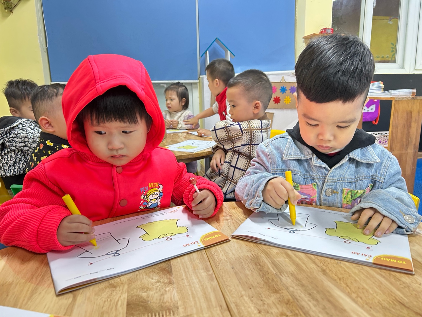 A group of children coloring on paper

AI-generated content may be incorrect.