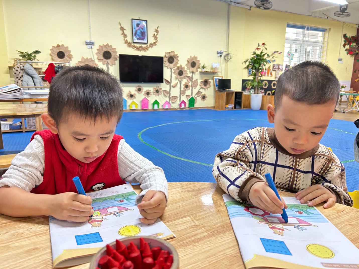 A group of young boys sitting at a table coloring

AI-generated content may be incorrect.