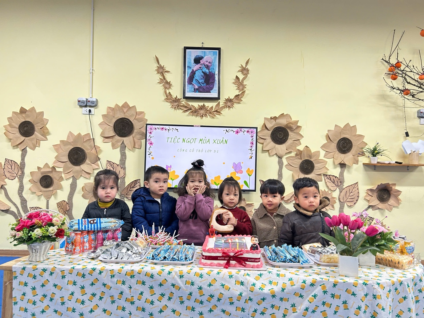 A group of children sitting at a table with food

AI-generated content may be incorrect.