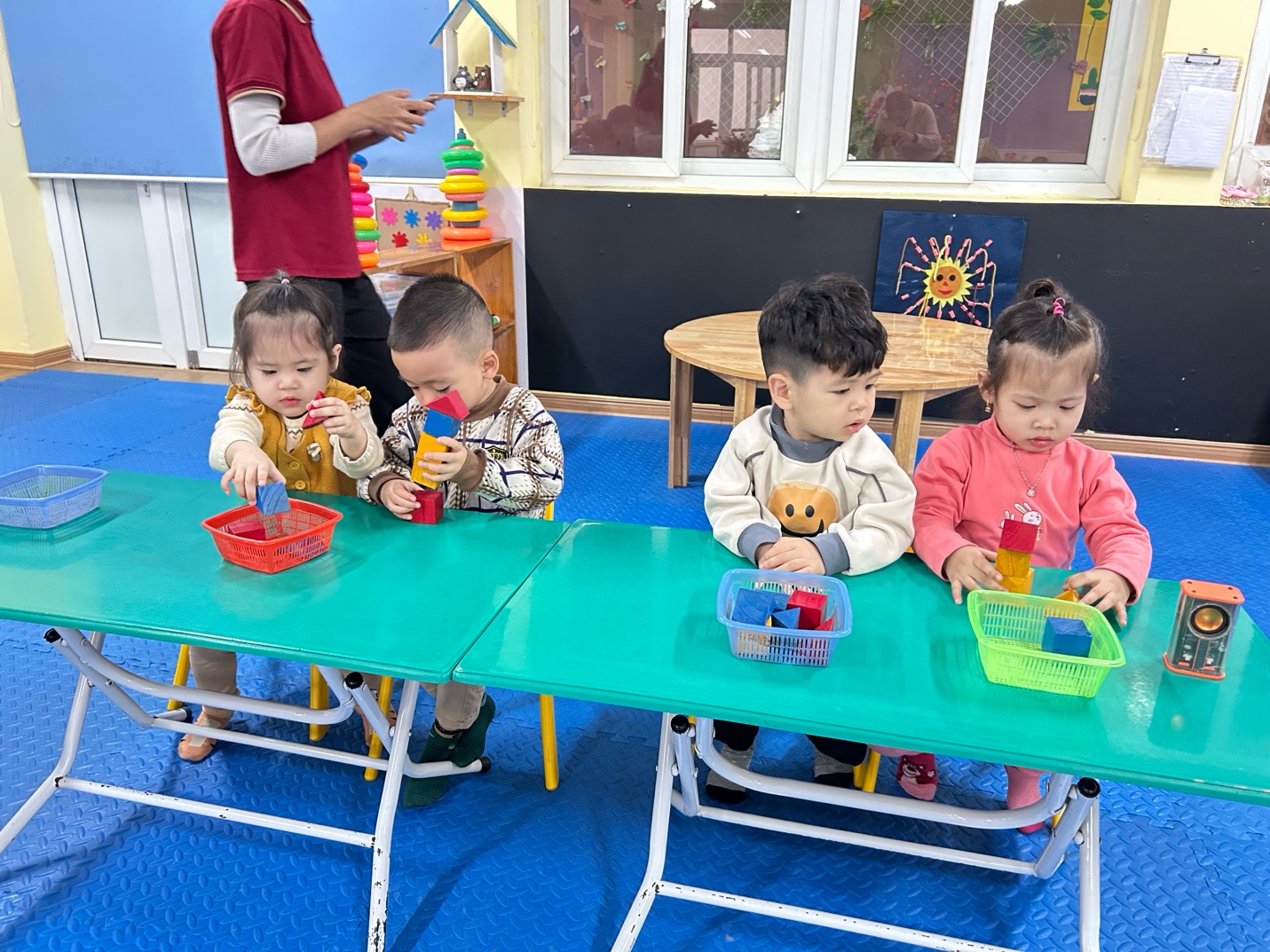 A group of children sitting at a table

AI-generated content may be incorrect.