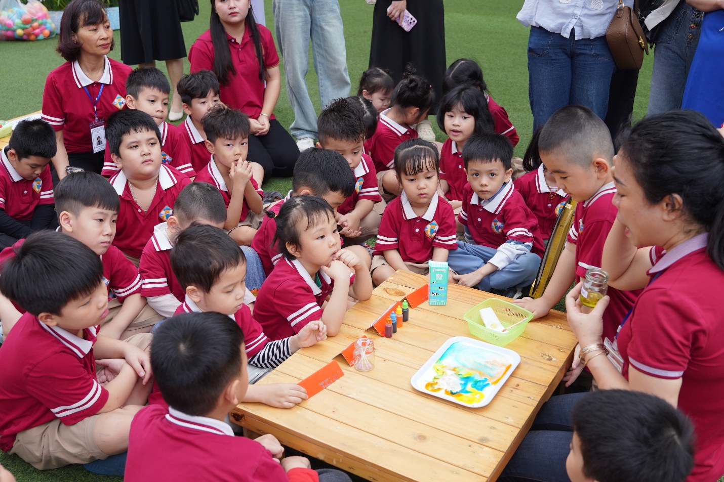 A group of children sitting around a table

AI-generated content may be incorrect.