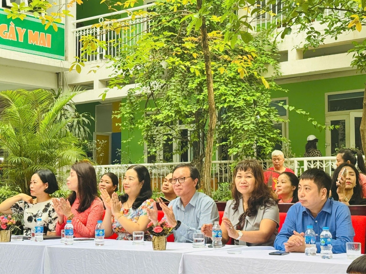 A group of people sitting at a tableAI-generated content may be incorrect.