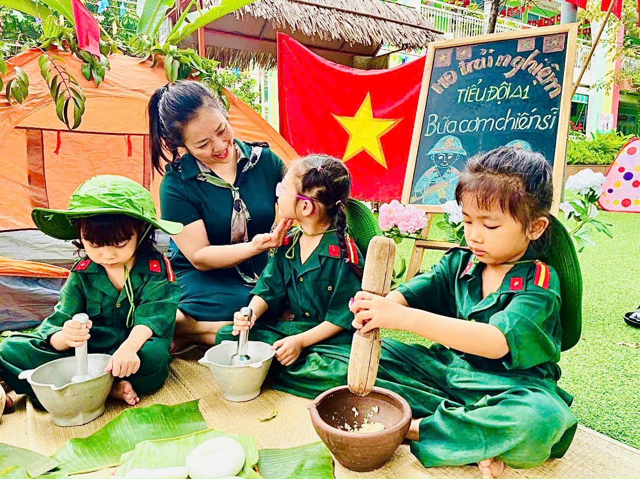 A group of kids in green uniforms sitting on a matAI-generated content may be incorrect.