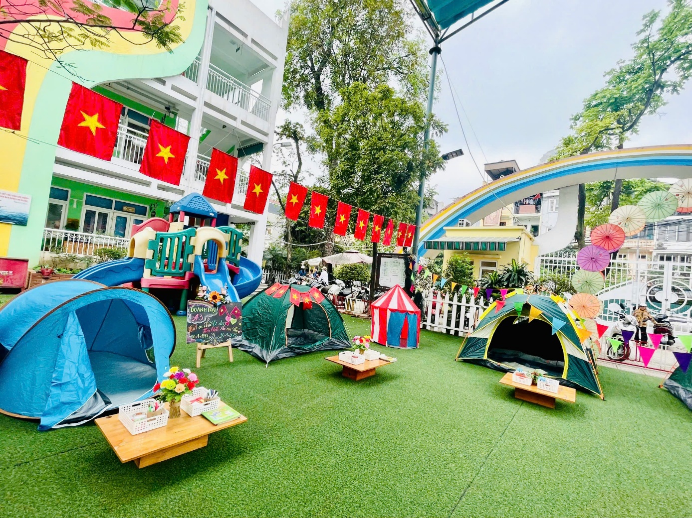 A playground with tents and flagsAI-generated content may be incorrect.